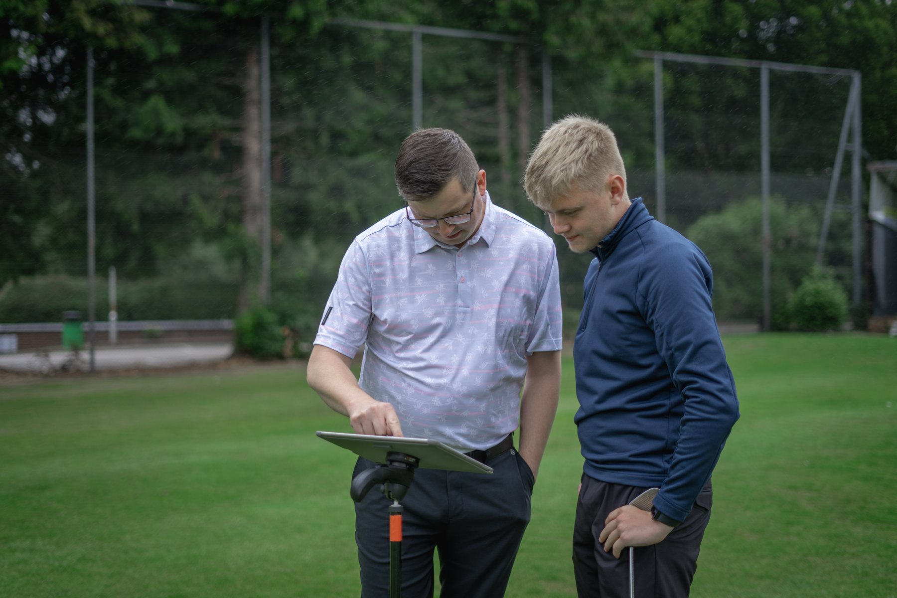 Steve Thomas reviewing swing video and data with a golfer during a lesson